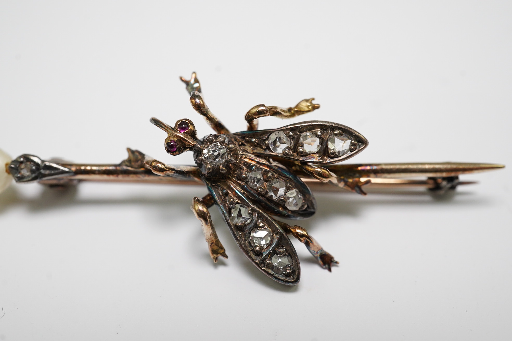 A Victorian gold and silver, pearl, rose and old cut diamond set 'bug' bar brooch